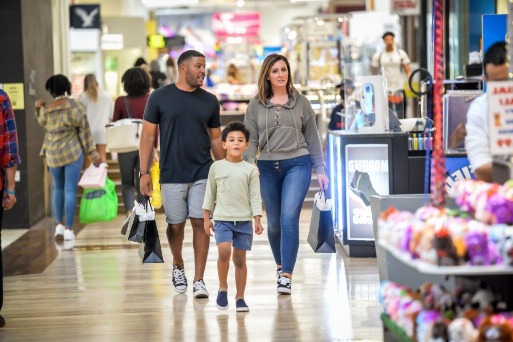 family walking in shopping mall